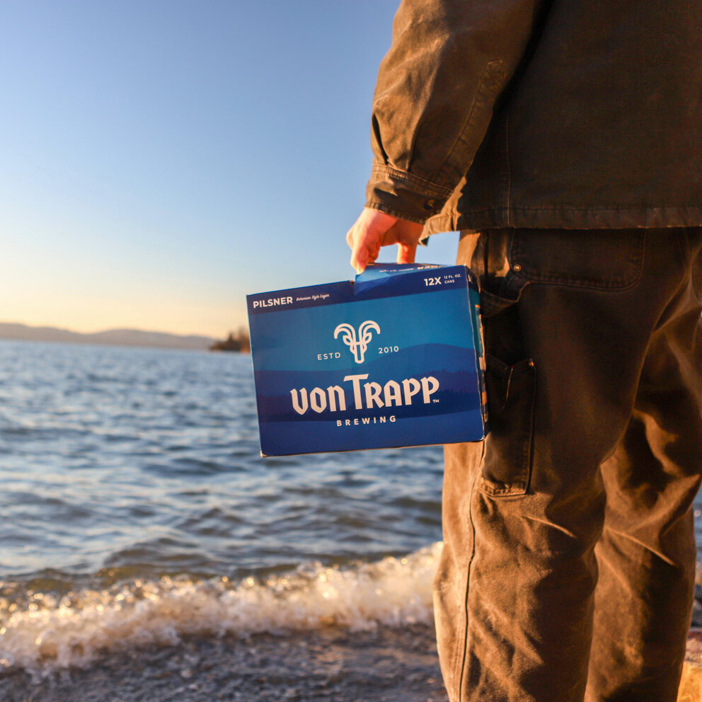 person holding box of pilsner