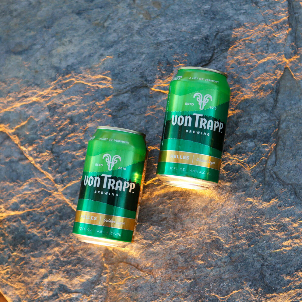 cans of helles on a rock