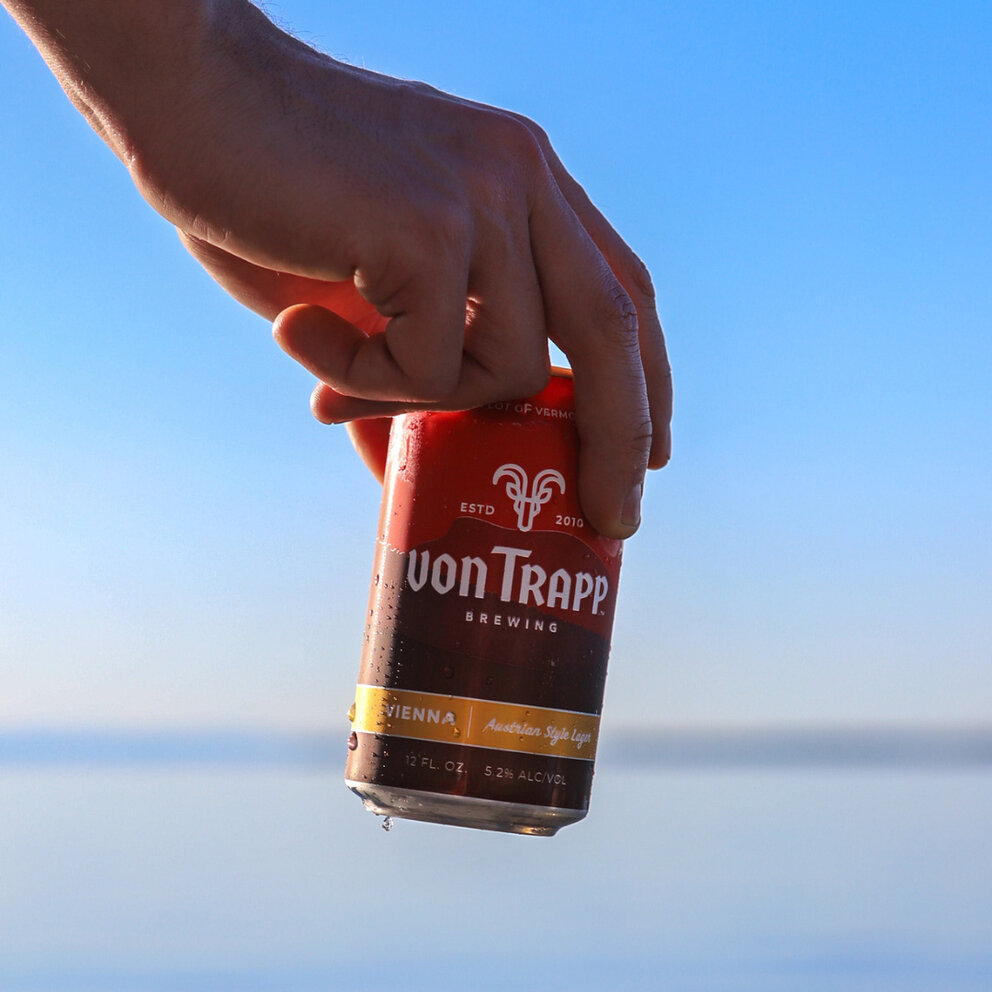 person holding can of vienna