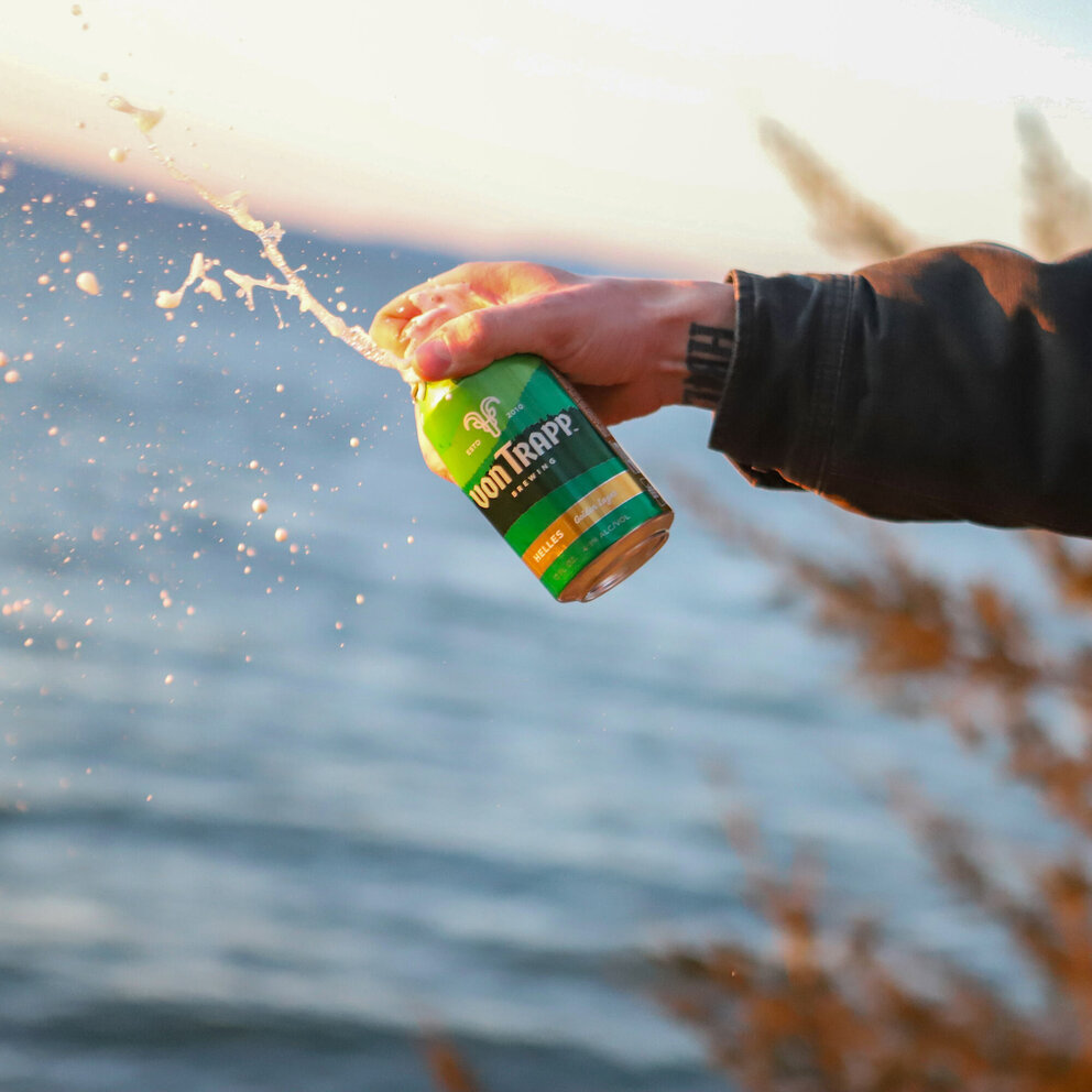 person spraying can of helles
