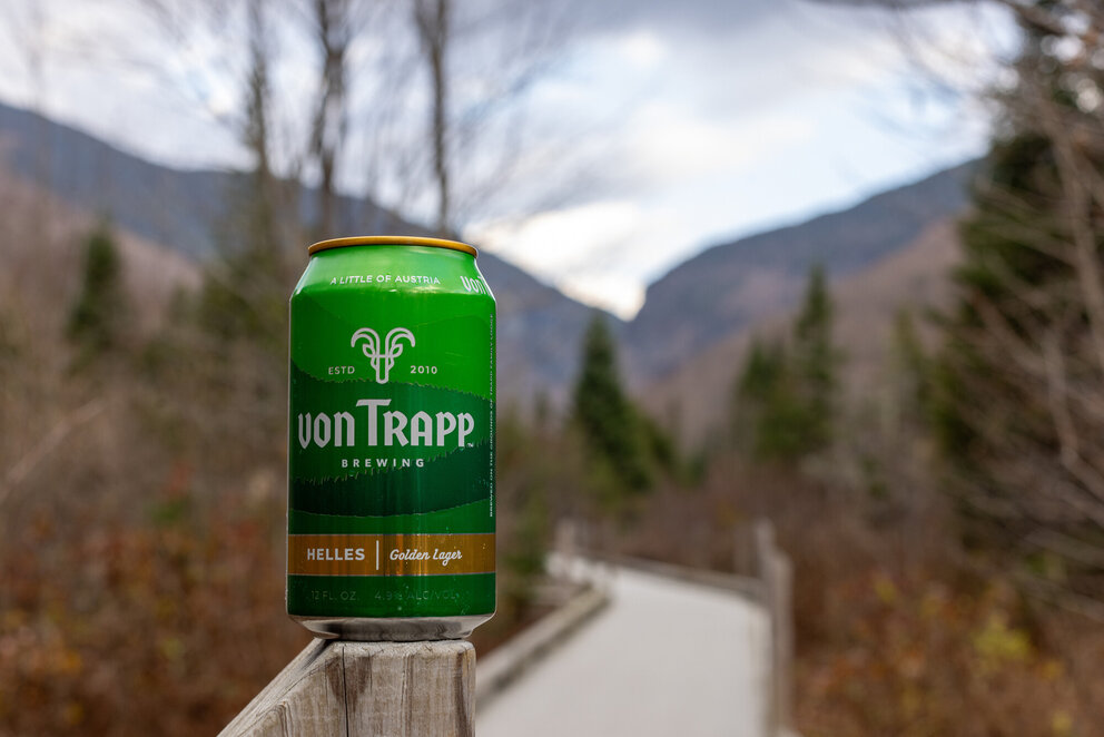 a green can on a wooden railing