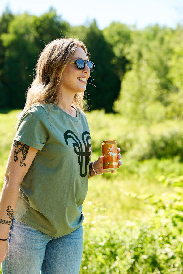 a woman holding a can outside