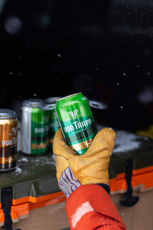 a hand holding a can of beer