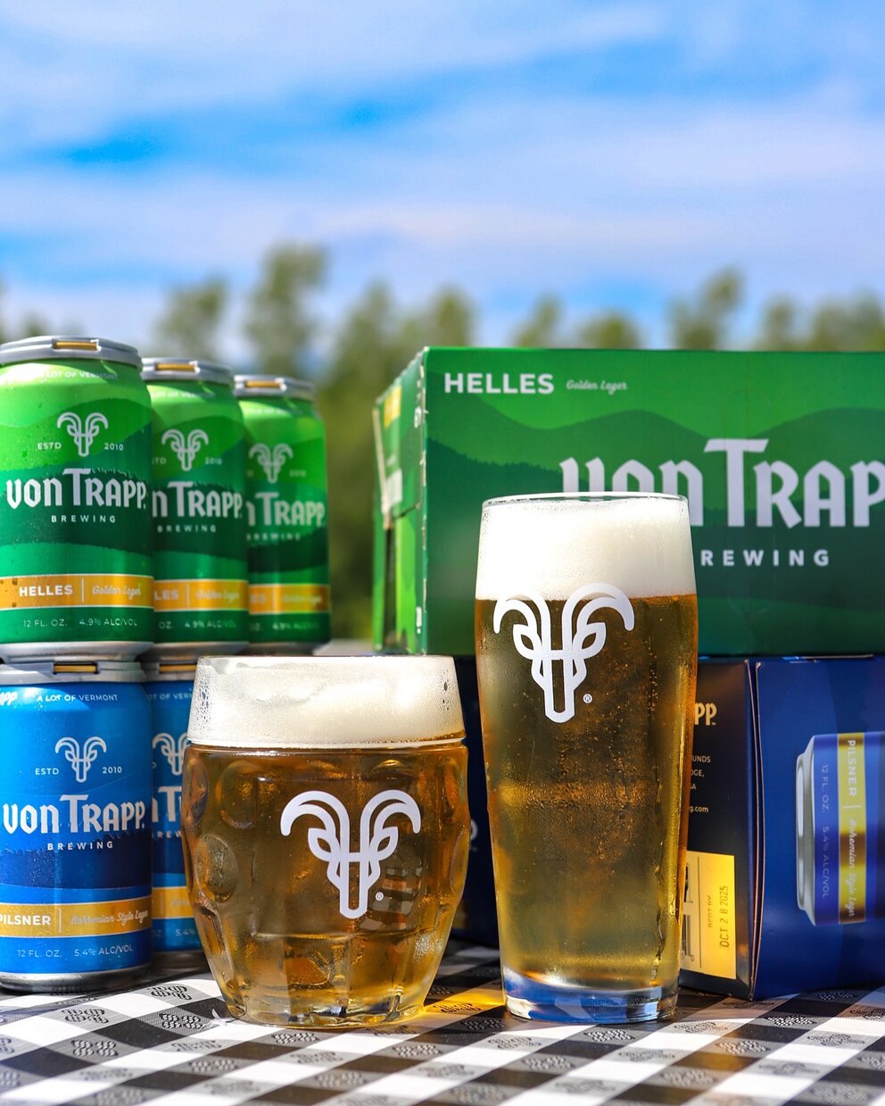 a group of cans and glasses of beer