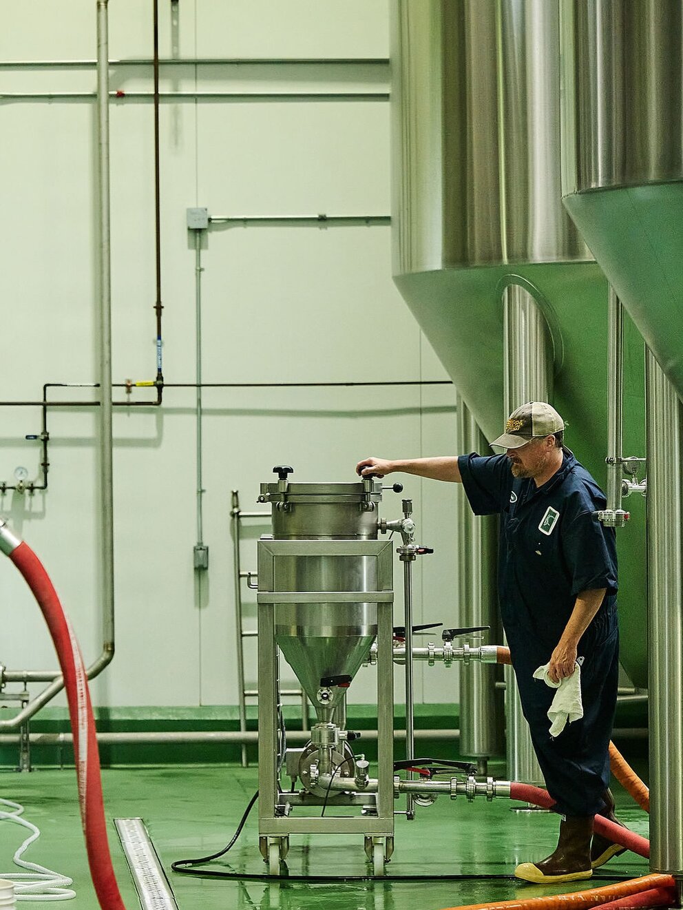 a man in a blue uniform standing next to a large metal container