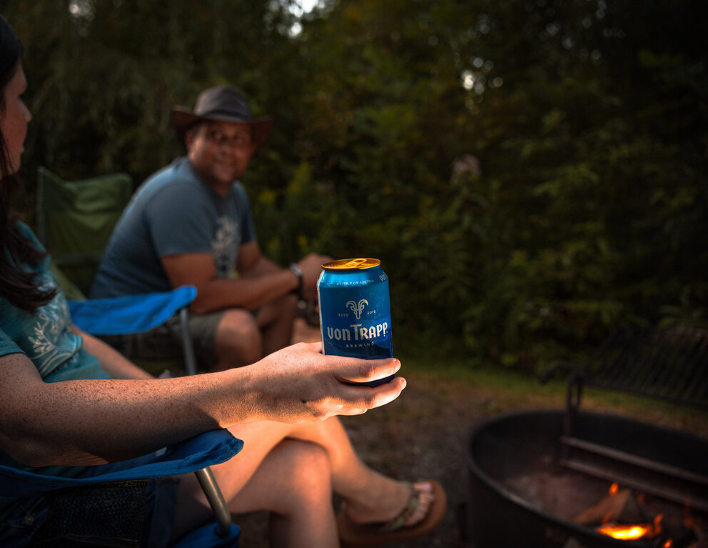 a person holding a can of beer