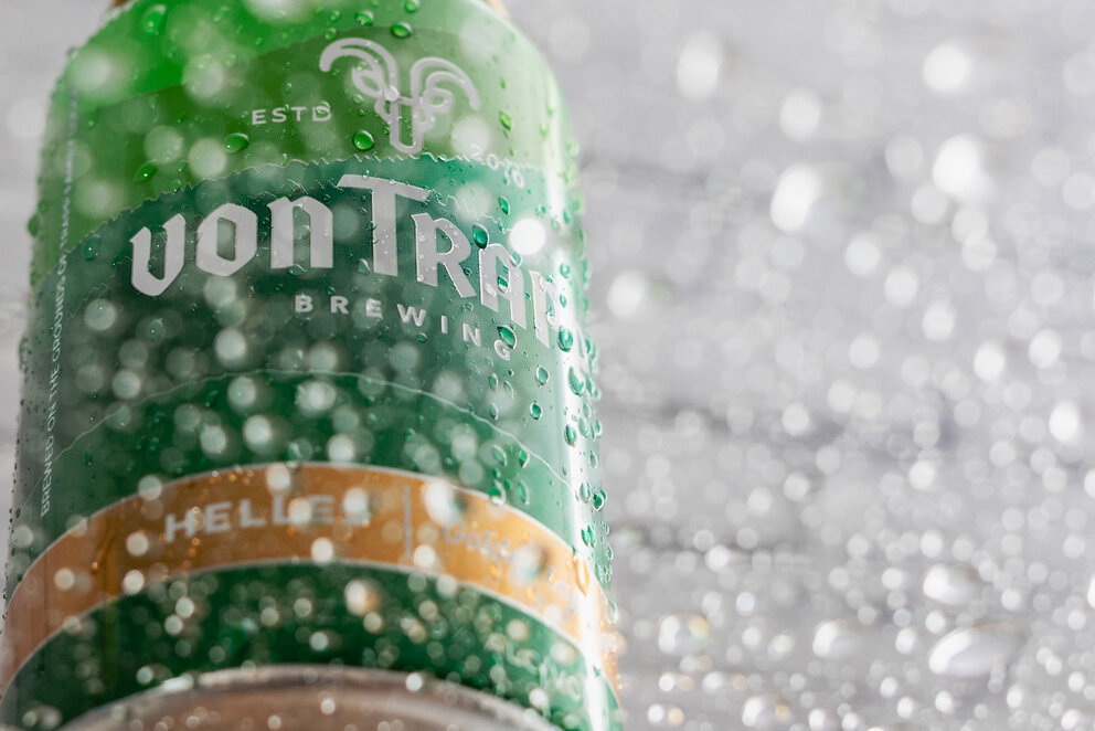 a green can with water drops on it